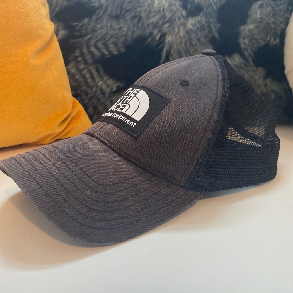 Weather worn The North Face black trucker hat